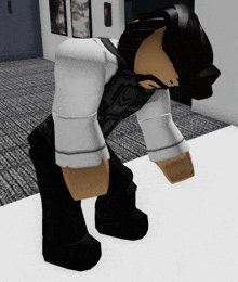 a person in a white shirt and black pants standing on a white surface