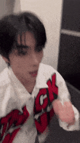 a blurry picture of a person wearing a red and white jacket with ck written on it