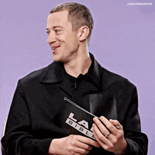 a man is holding a la bible in his hands