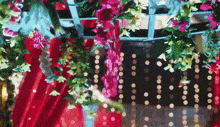 a red curtain with flowers and lights hanging from it .