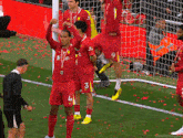 a group of soccer players wearing red uniforms with the number 3 on them
