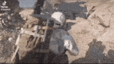 a man in a helmet is holding a gun in a video game .