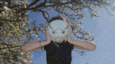 a person with a mask on covering their ears