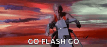 a man is riding a motorcycle in the desert with the words `` go flash go '' written on the screen .
