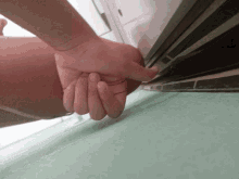 a person 's hand is reaching up to a ceiling