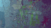 a man and a woman are standing in front of a wall with graffiti on it including the letters o and t