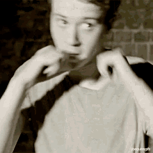 a black and white photo of a young man with the caption joeguilinggifs