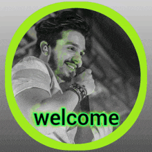 a black and white photo of a man holding a microphone with the words welcome written in the corner