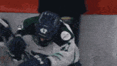 a hockey player wearing a helmet with the number 47 on it