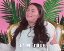 a woman with long hair is sitting in a chair with her eyes closed and says `` i 'm out '' .