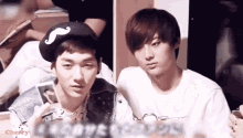 two young men are sitting next to each other with the word cherry visible in the corner