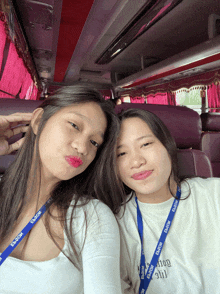 two girls are posing for a picture and one has a lanyard that says escor
