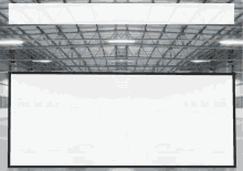 a large white sign is hanging from the ceiling of a large building