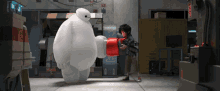 Trying To Put A Condom On Him When He'S Not Ready Yet GIF - Big Hero Six Baymas Suit GIFs