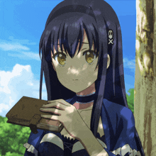 a girl with a x on her head holds a book