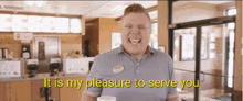 a man in a gray shirt is holding a cup and smiling with the words " it is my pleasure to serve you " behind him
