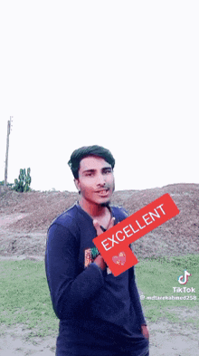 a young man is holding a red sign that says excellent