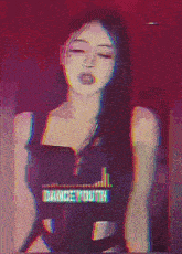a woman wearing a dance youth shirt stands in front of a red background