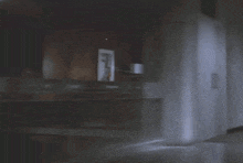 a refrigerator is open in a dark kitchen