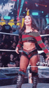 a woman in a freddy krueger costume is standing in a ring