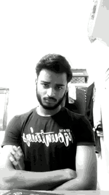 a man with a beard is wearing a black shirt that says ' squat mojo ' on it