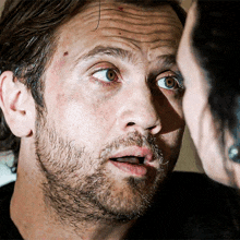a man with a beard is looking at a woman