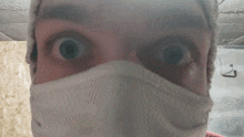 a close up of a person 's face with a white mask on
