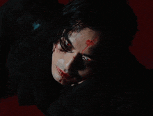 a man with blood on his face is laying on the floor