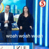 a man and a woman are dancing in front of a sign that says would like to thank