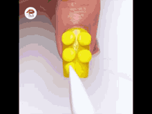 a person 's nails are painted yellow to look like lego bricks