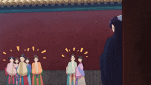 a group of women are standing in front of a red wall