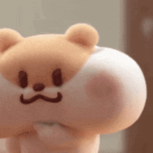 a close up of a stuffed animal with a face drawn on it 's back .
