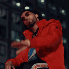 a man in a red jacket with the word wait written on it