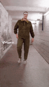 a man is walking down a hallway with a sign that says viggle.ai on the bottom