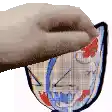 a hand is holding a drawing of a face on a piece of paper .