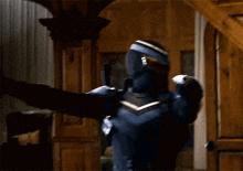 a man in a superhero costume is pointing a gun at something