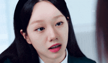 a close up of a girl with braces on her teeth and a headband