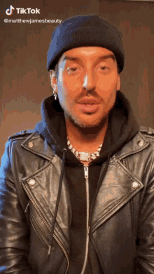 a man wearing a black beanie and a black leather jacket has a tiktok account