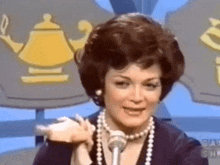 a woman is talking into a microphone on a television show .