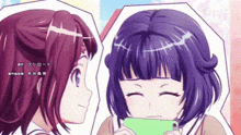 two anime girls are standing next to each other and one is holding a green phone .