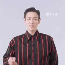 a man wearing a black and red striped shirt with netflix written on the bottom right