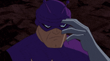 a cartoon character wearing a purple mask and hat