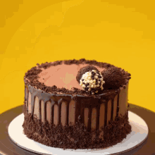 a chocolate cake with a truffle on top is on a table