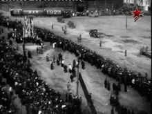a black and white photo of a crowd watching a race on march 19th