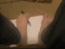 a person is writing on a piece of paper with their bare feet .
