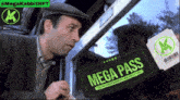 a man is looking at a ticket that says mega pass on it