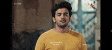 a man in a yellow shirt is on a screen that says star plus hd