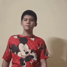 a young boy with short hair is making a funny face .
