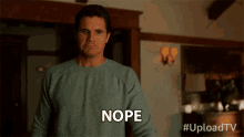 a man in a grey sweater says nope in front of a #uploadtv logo