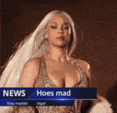a woman with white hair is on a news channel